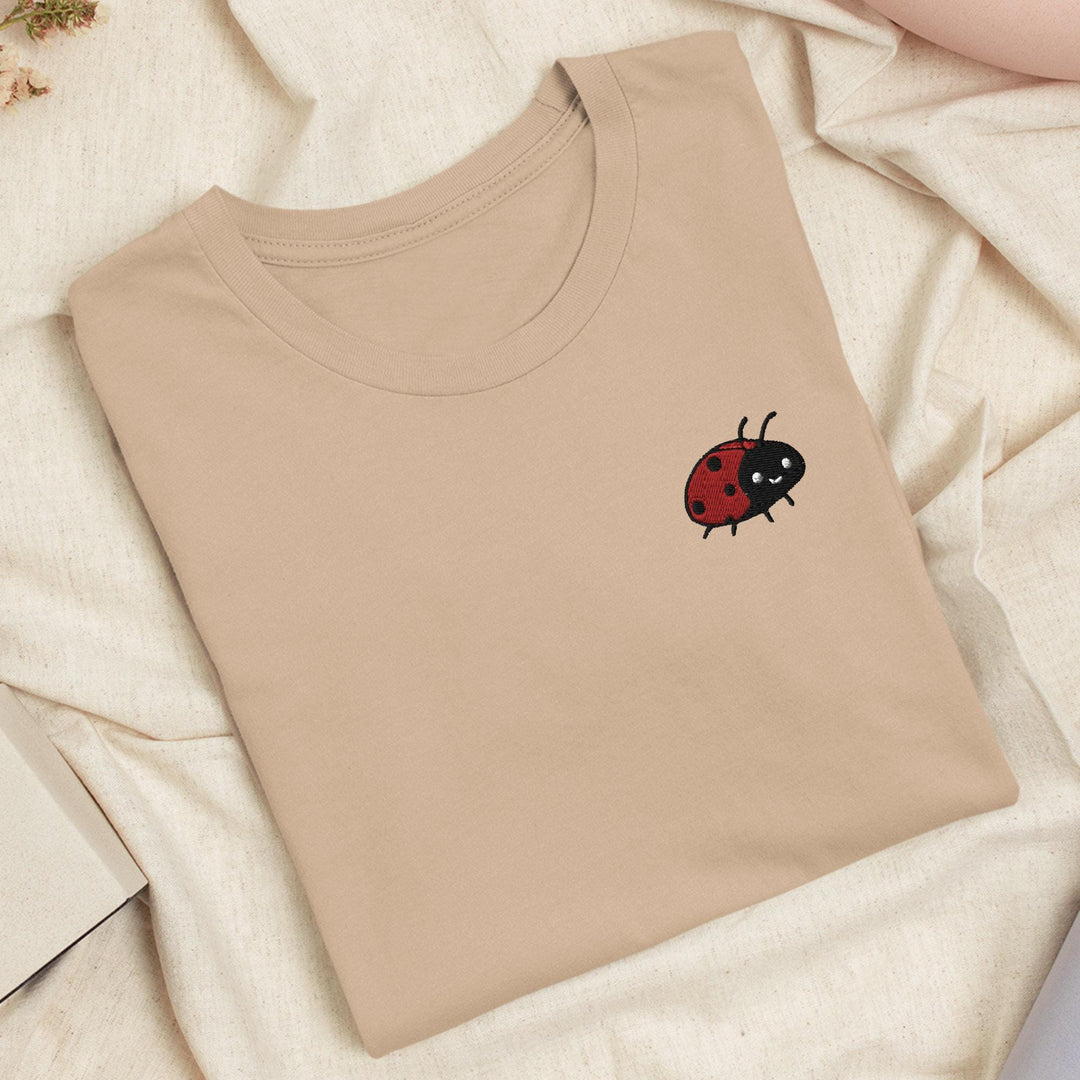 a t - shirt with a ladybug embroidered on it