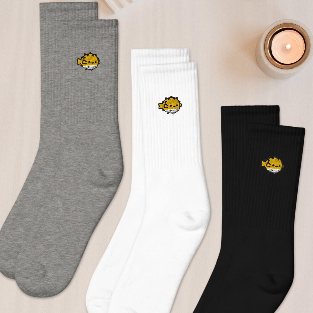 three pairs of socks sitting on top of a table