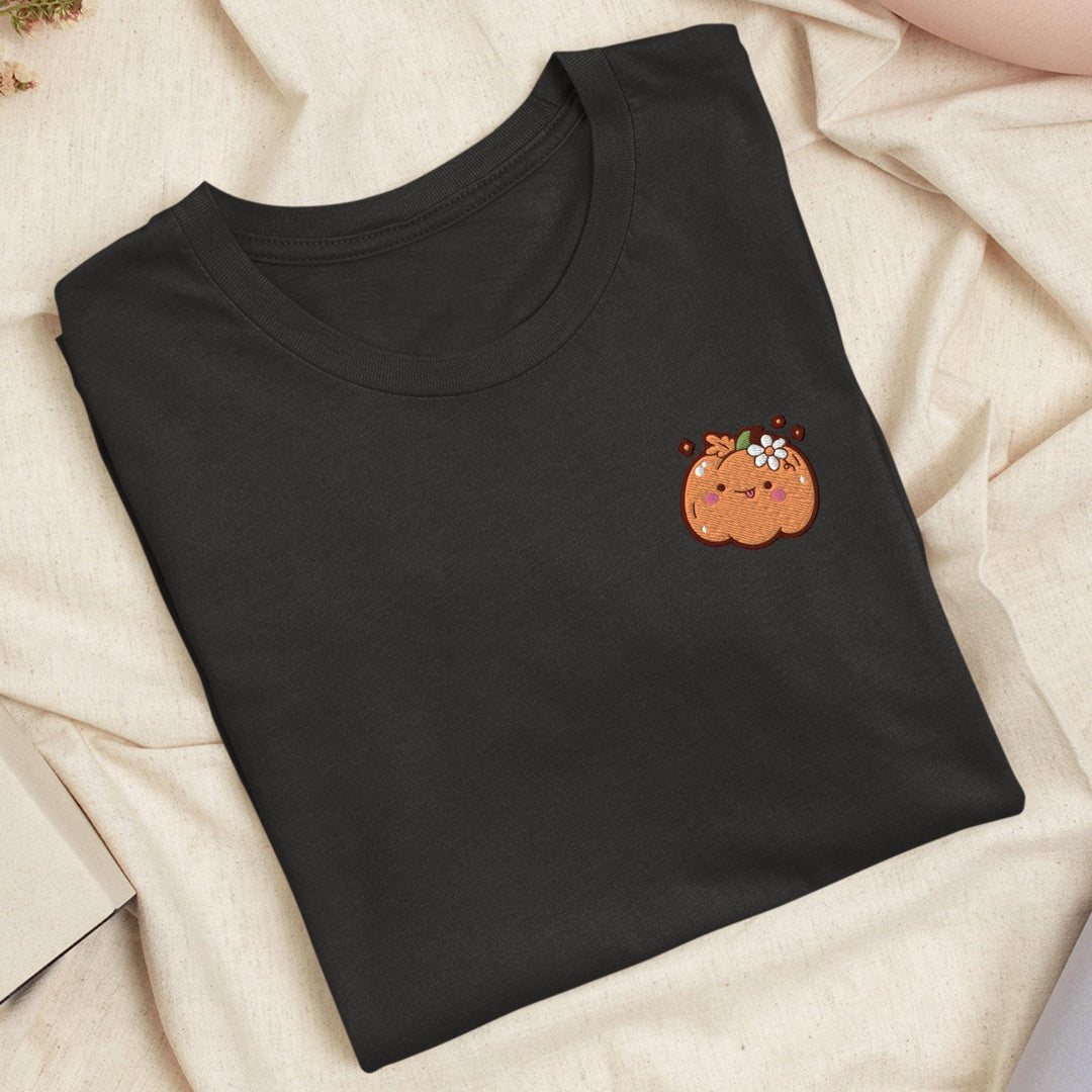 a black t - shirt with a picture of a pumpkin on it