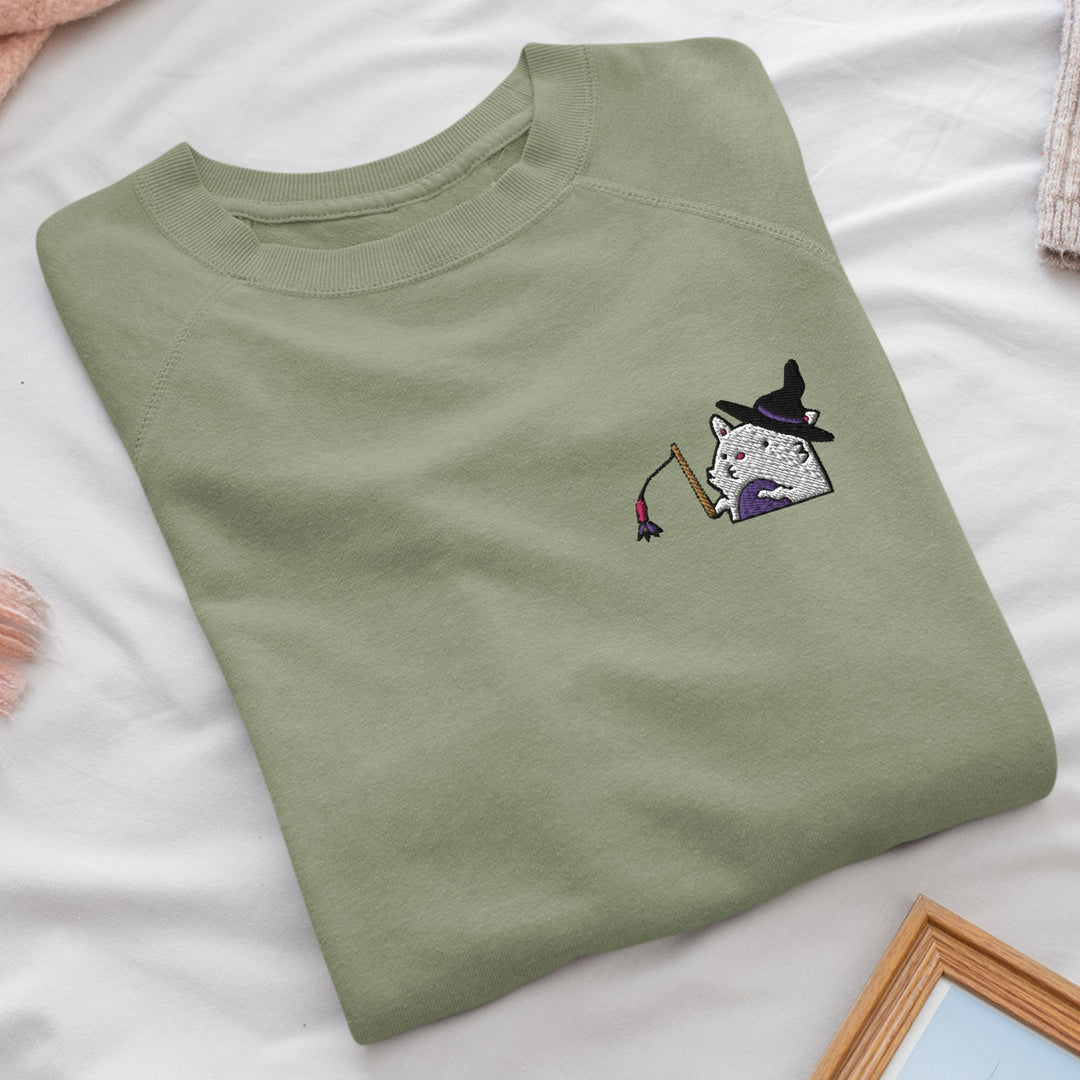 a green t - shirt with a picture of a cat on it