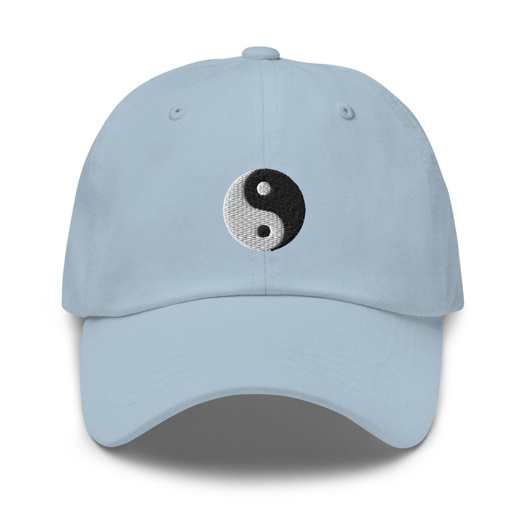 a light blue hat with a black and white yin yang symbol on it