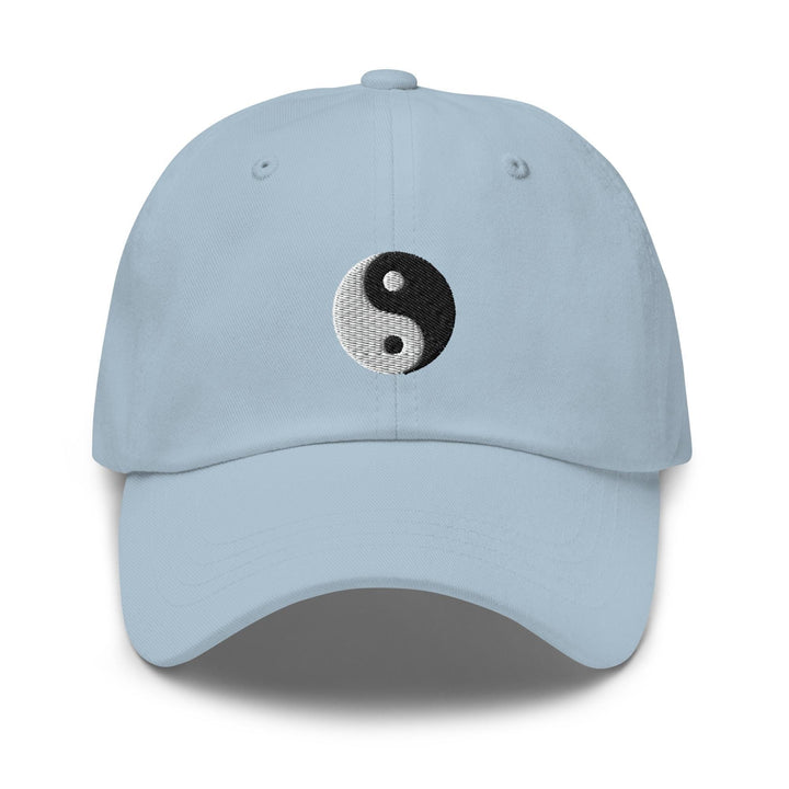 a light blue hat with a black and white yin yang symbol on it