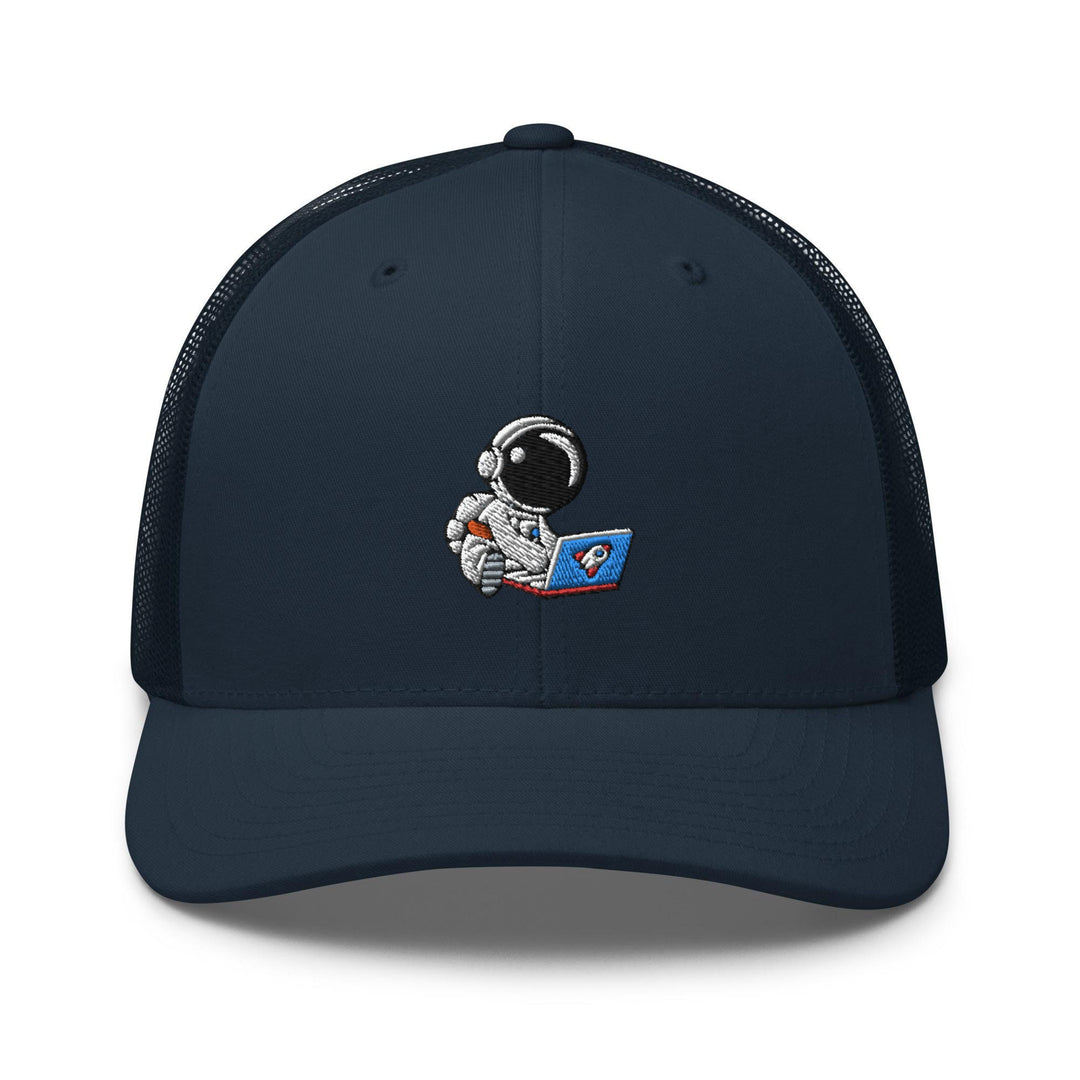 a trucker hat with an astronaut reading a book