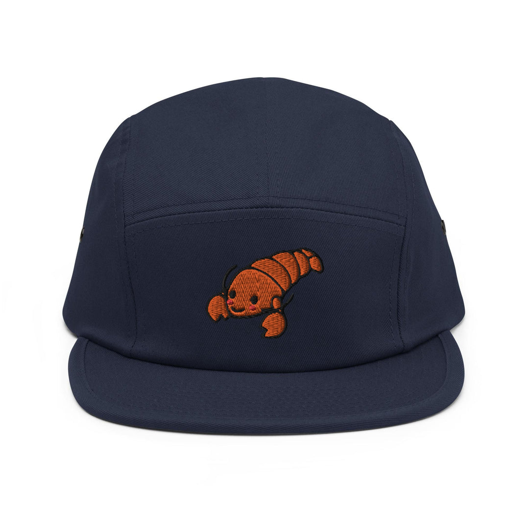 a blue hat with an orange fish embroidered on it