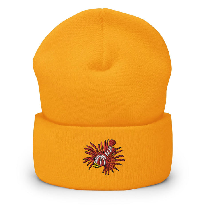 a yellow beanie with a picture of a fish on it