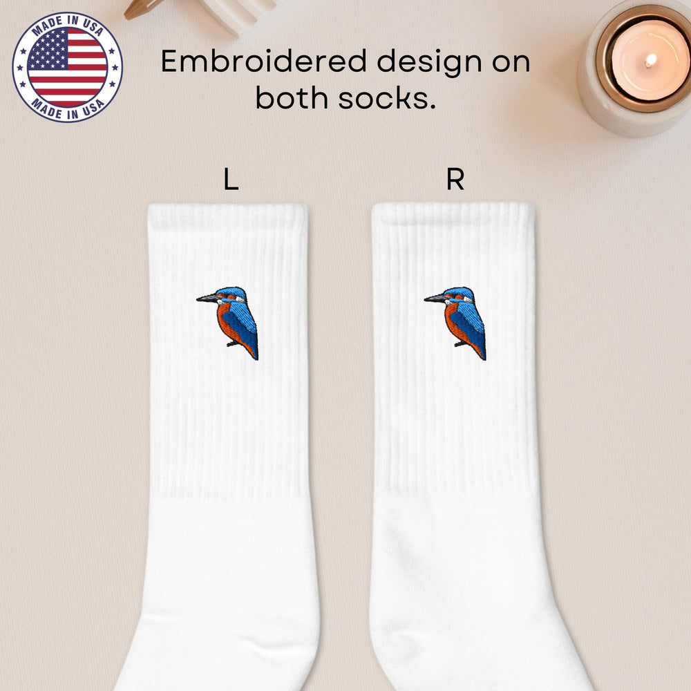 a pair of white socks with a blue bird on it