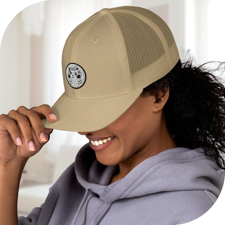 a woman wearing a tan hat and a gray hoodie