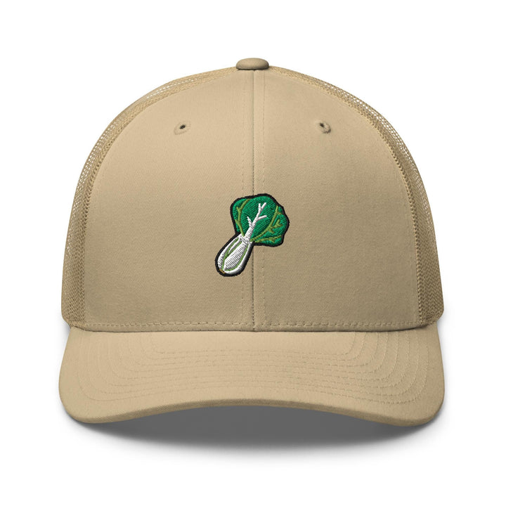 a tan trucker hat with a green leaf on it