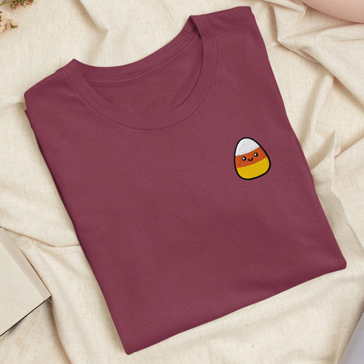 a t - shirt with a picture of a candy corn on it