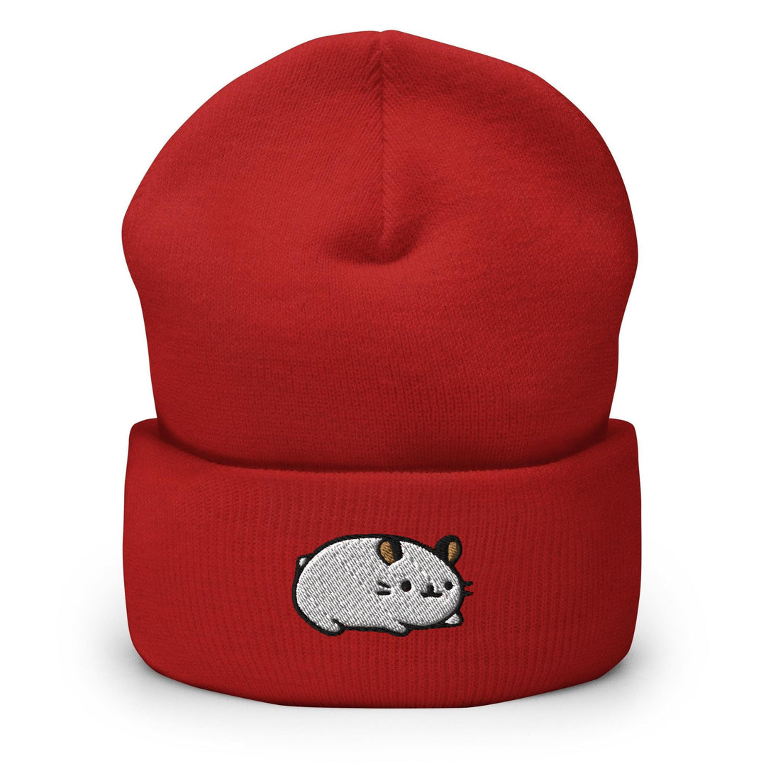a red beanie with a cartoon of a cow on it