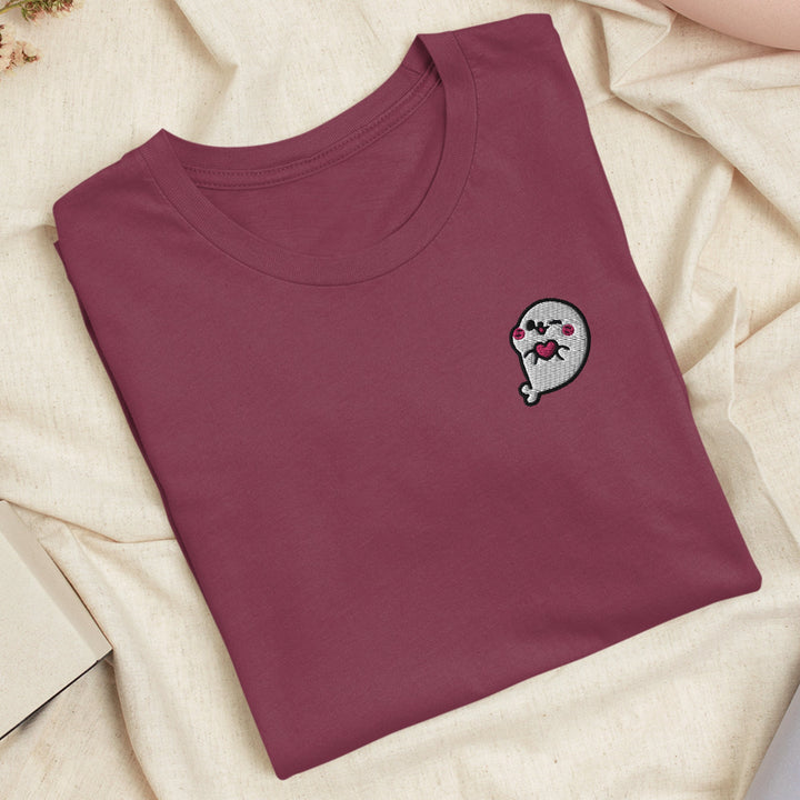 a t - shirt with a sticker of a ghost on it