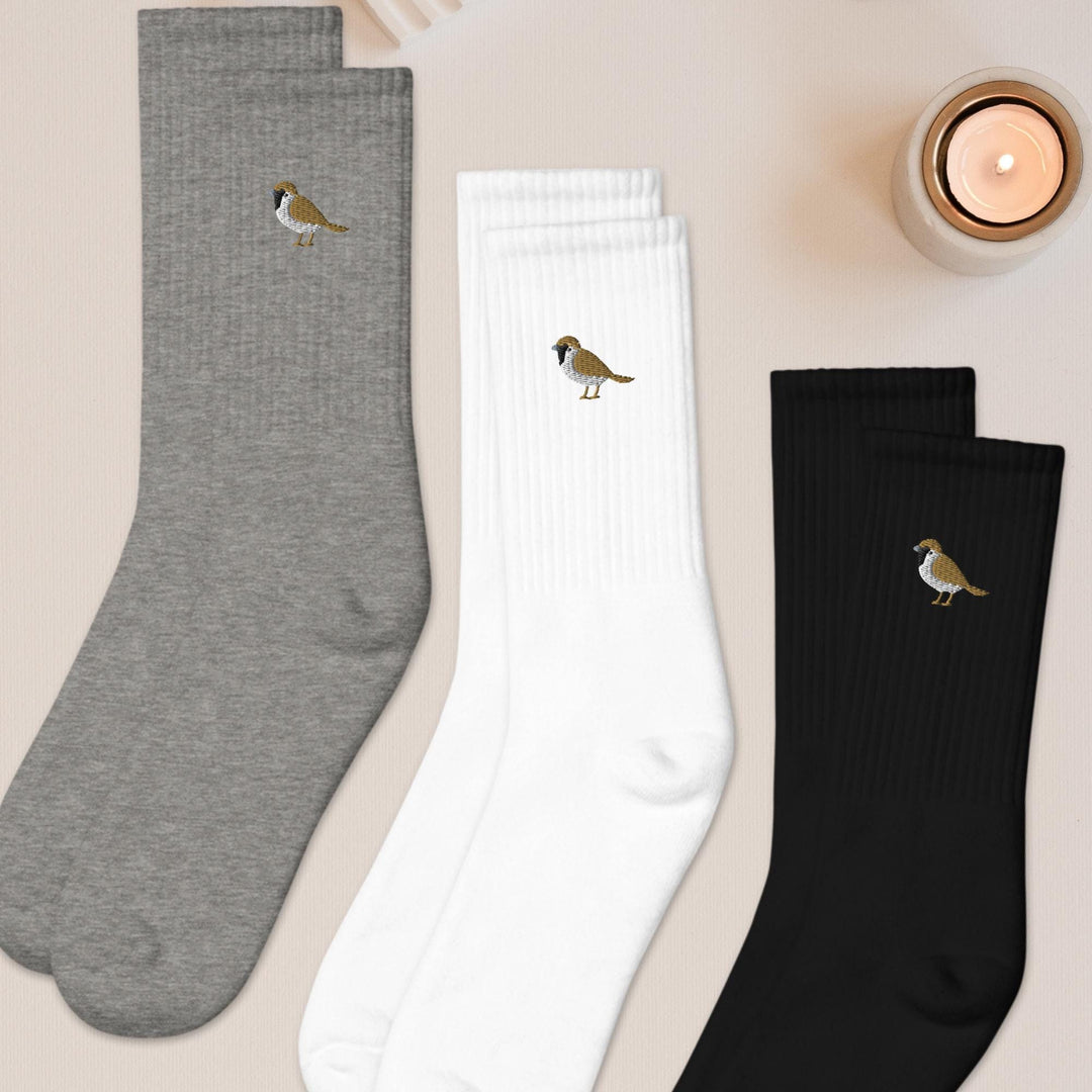 three pairs of socks with birds on them