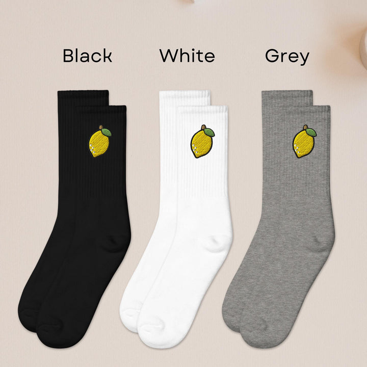 three pairs of black, white, and grey socks with lemons on them