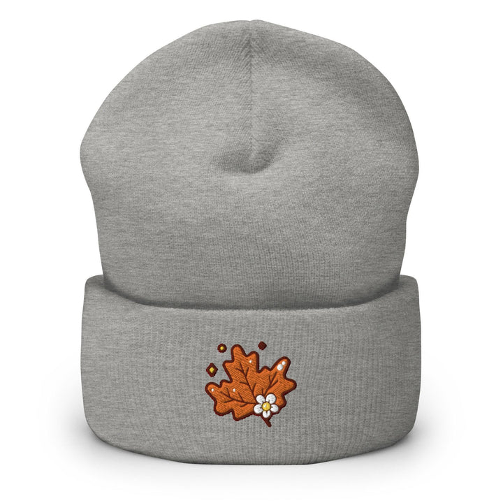 a grey beanie with an orange maple on it