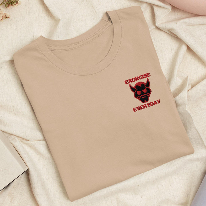 a t - shirt with a skull on it sitting on a bed