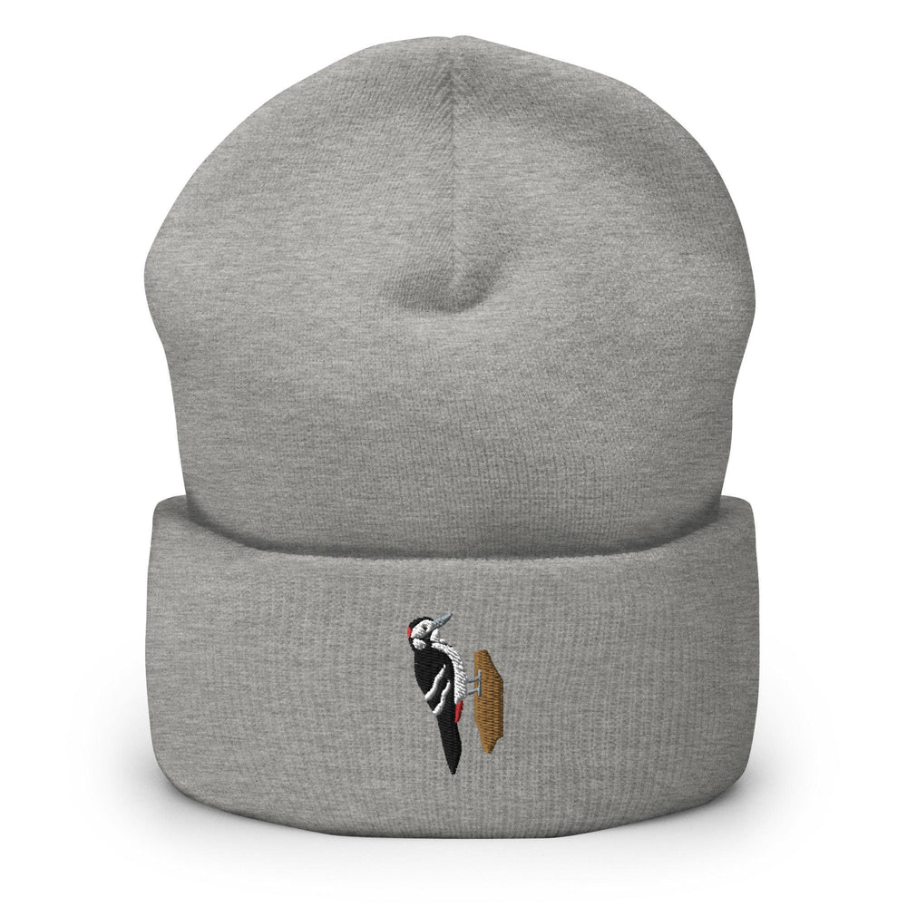 a grey beanie with a black and white bird on it