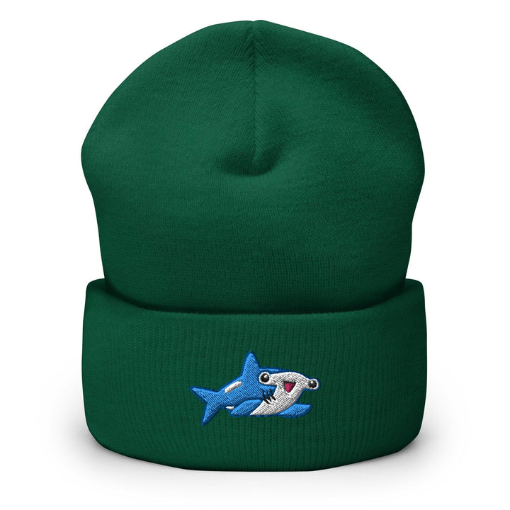 a green beanie with a shark embroidered on it