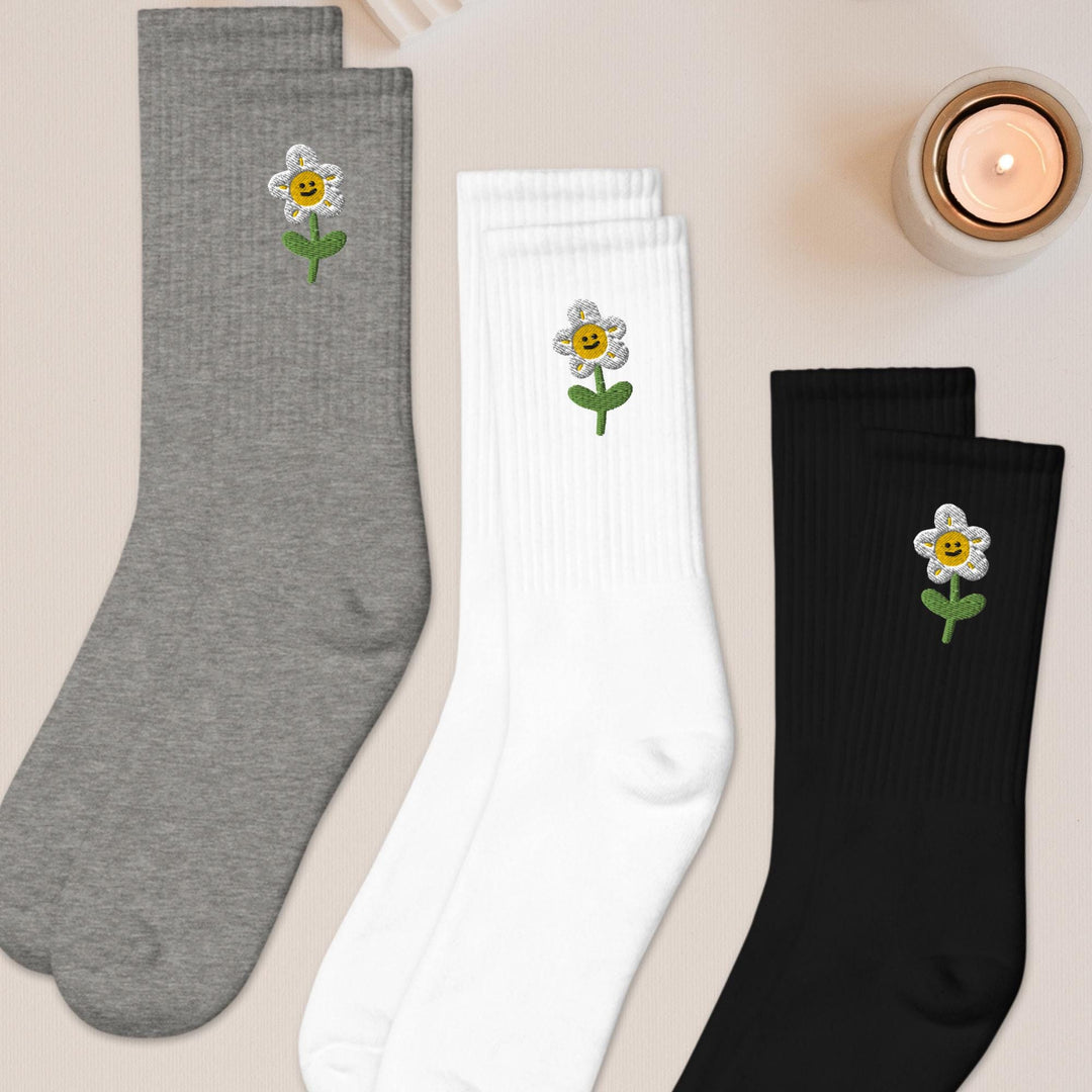 three pairs of socks with flowers on them