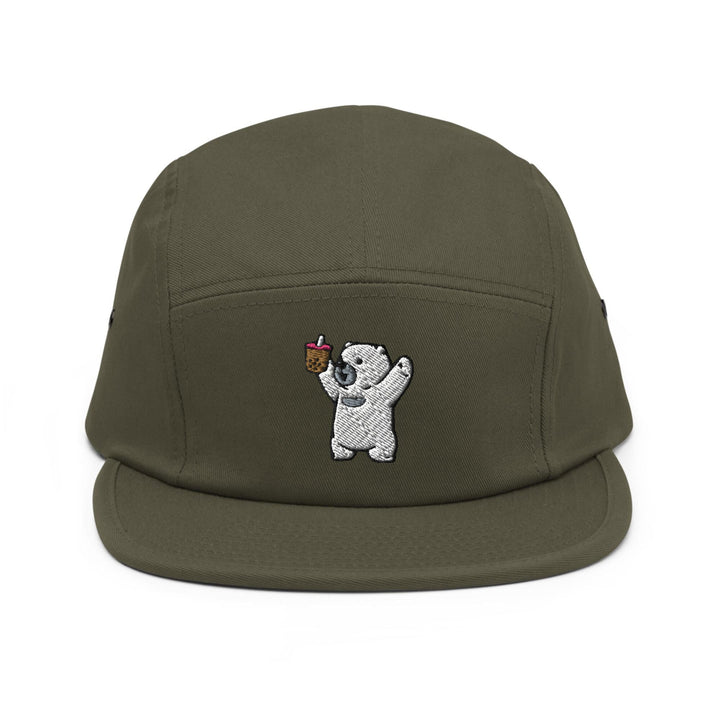 a green hat with a white bear holding an apple