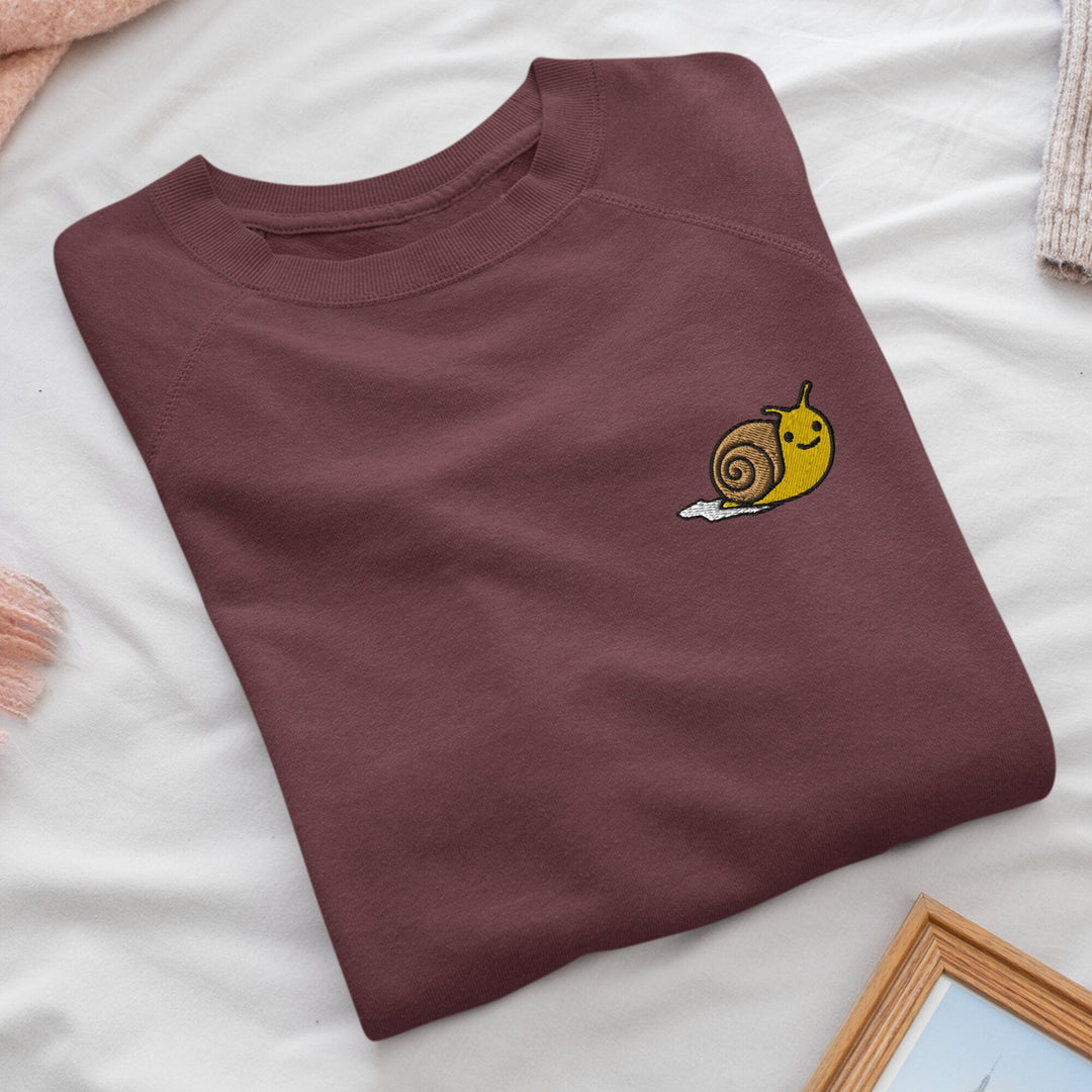 a t - shirt with a snail embroidered on it