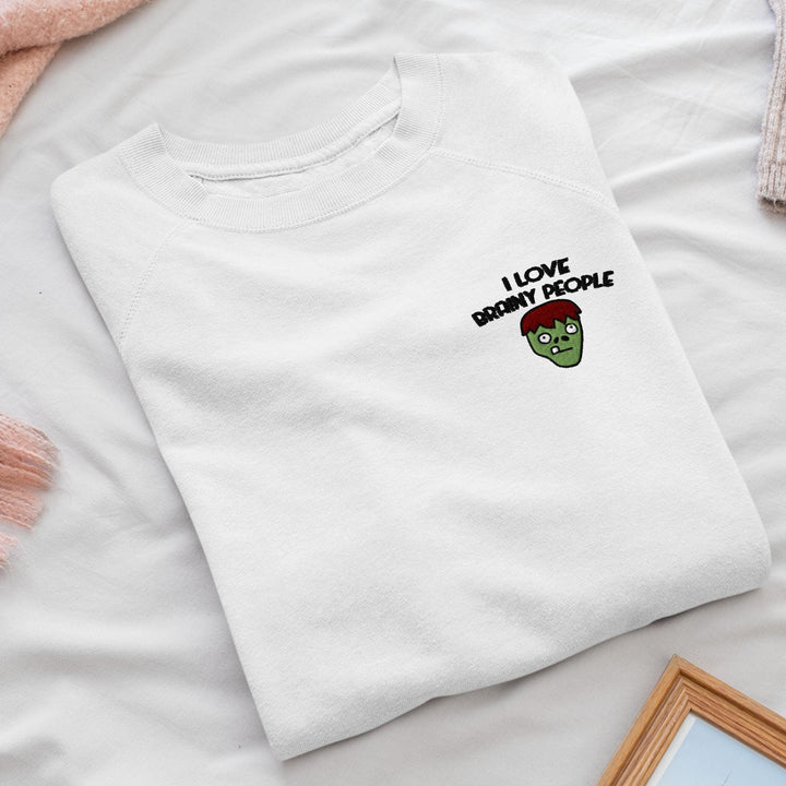 a white t - shirt that says i love being a zombie