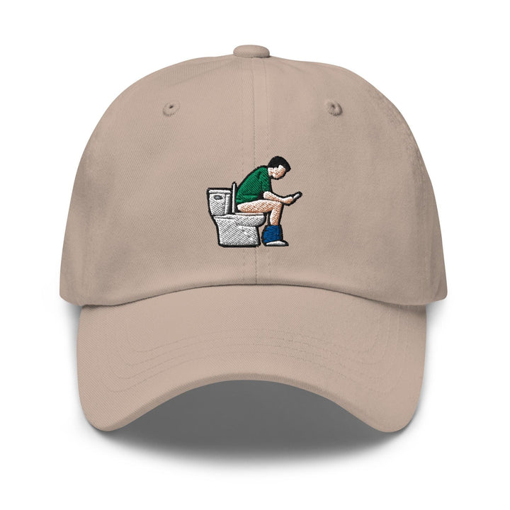 a baseball cap with a picture of a man sitting on a toilet