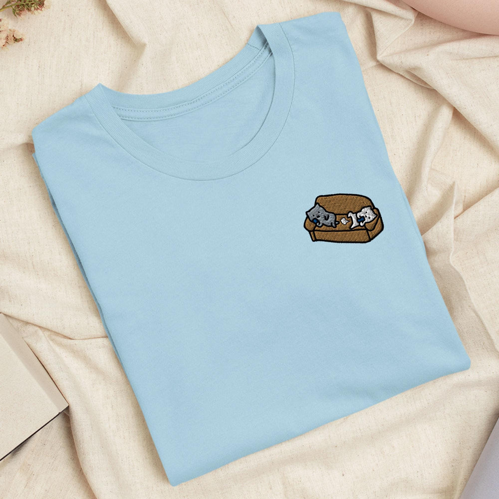 a blue t - shirt with a picture of a dog and a cat in a