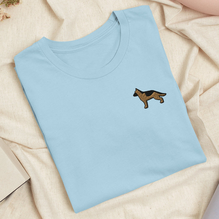 a blue t - shirt with a dog embroidered on it