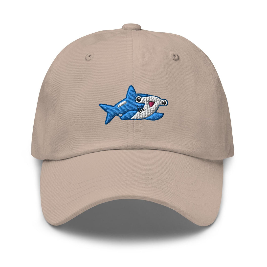 a tan hat with a shark embroidered on it