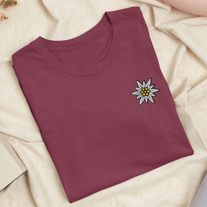 a red t - shirt with a flower on it