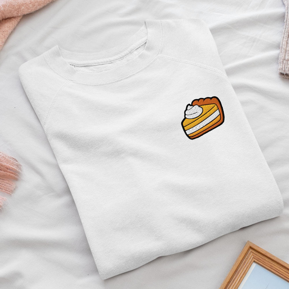 a white t - shirt with a piece of cake on it