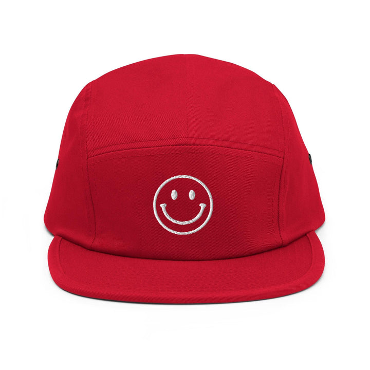 a red hat with a smiley face drawn on it