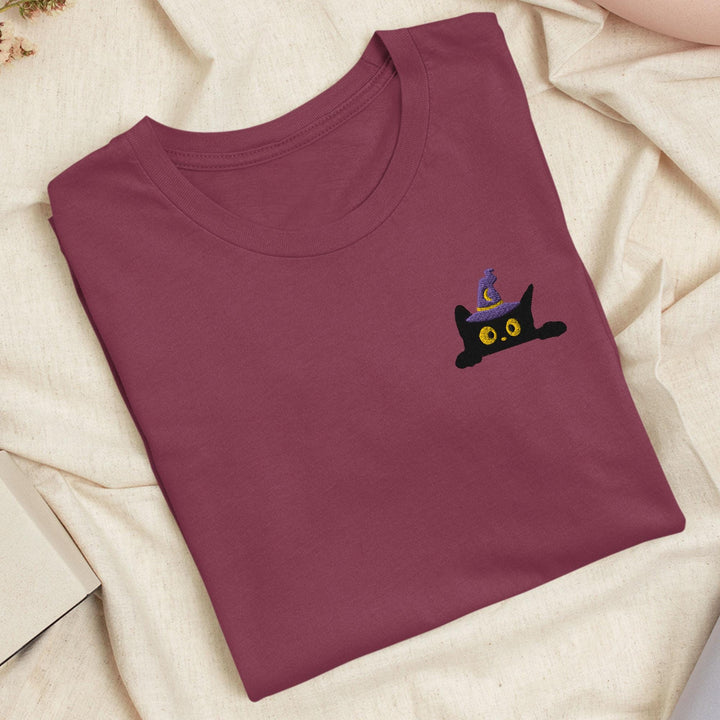 a t - shirt with a black cat embroidered on it