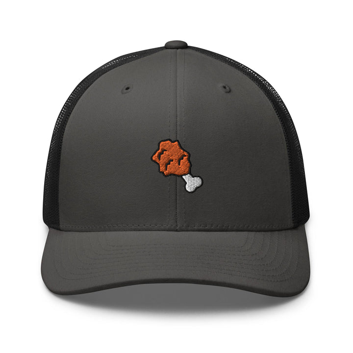 a gray and black trucker hat with an orange bear on it
