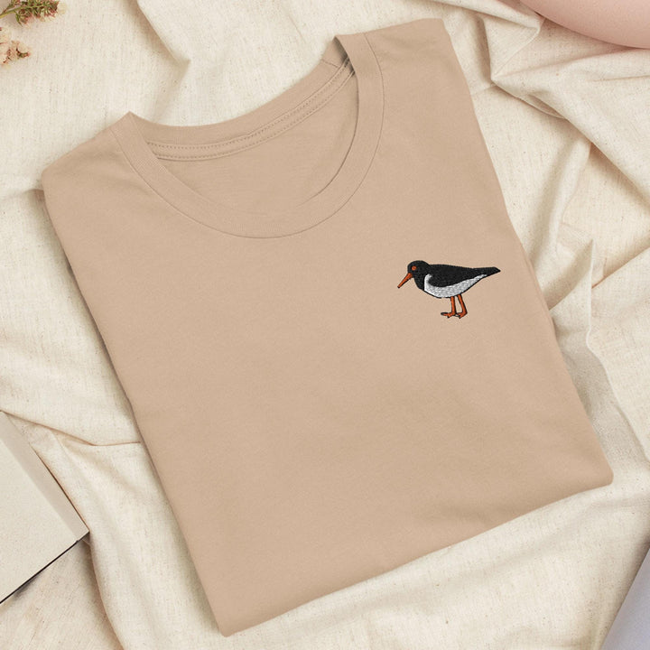 a t - shirt with a bird embroidered on it