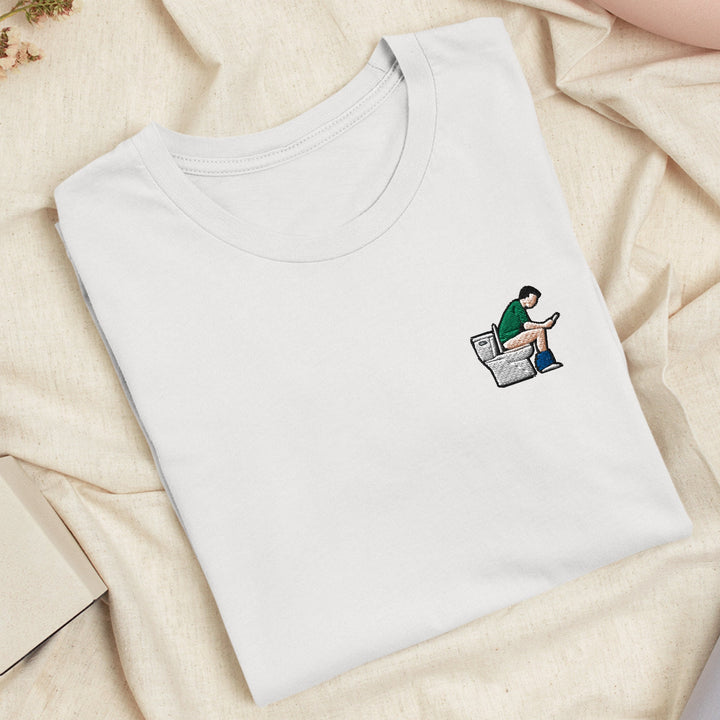 a white t - shirt with a picture of a man sitting on top of a