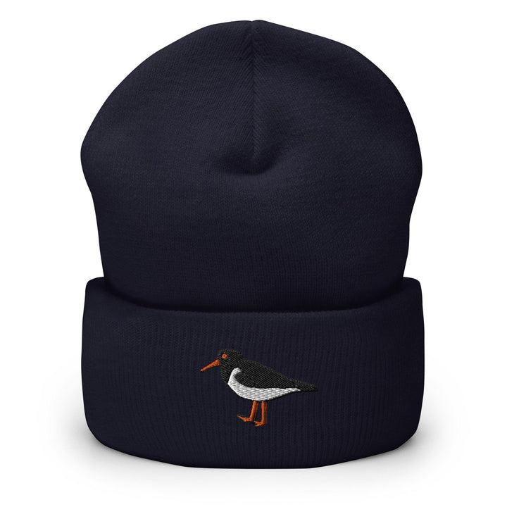 a black and white bird on a blue beanie