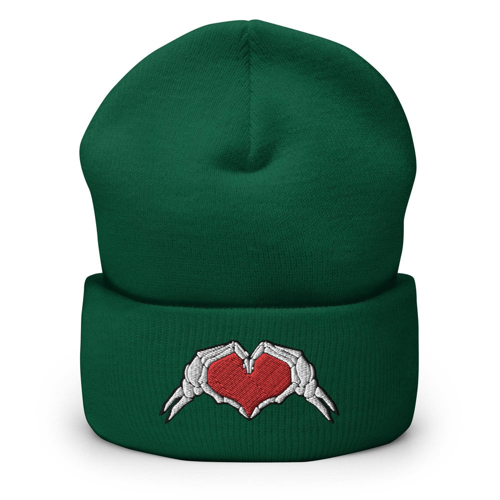 a green beanie with two hands holding a heart