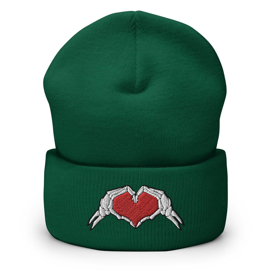 a green beanie with two hands holding a heart