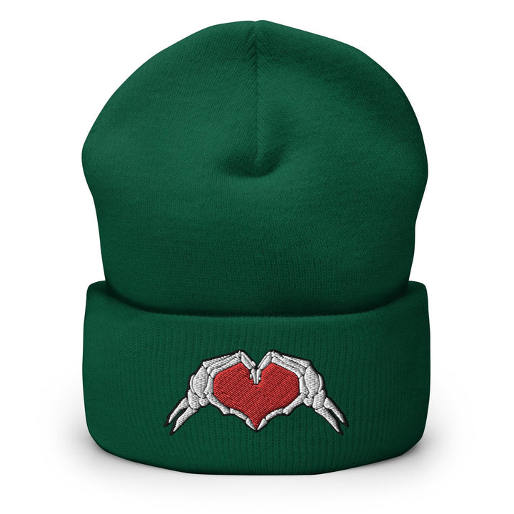 a green beanie with two hands holding a heart