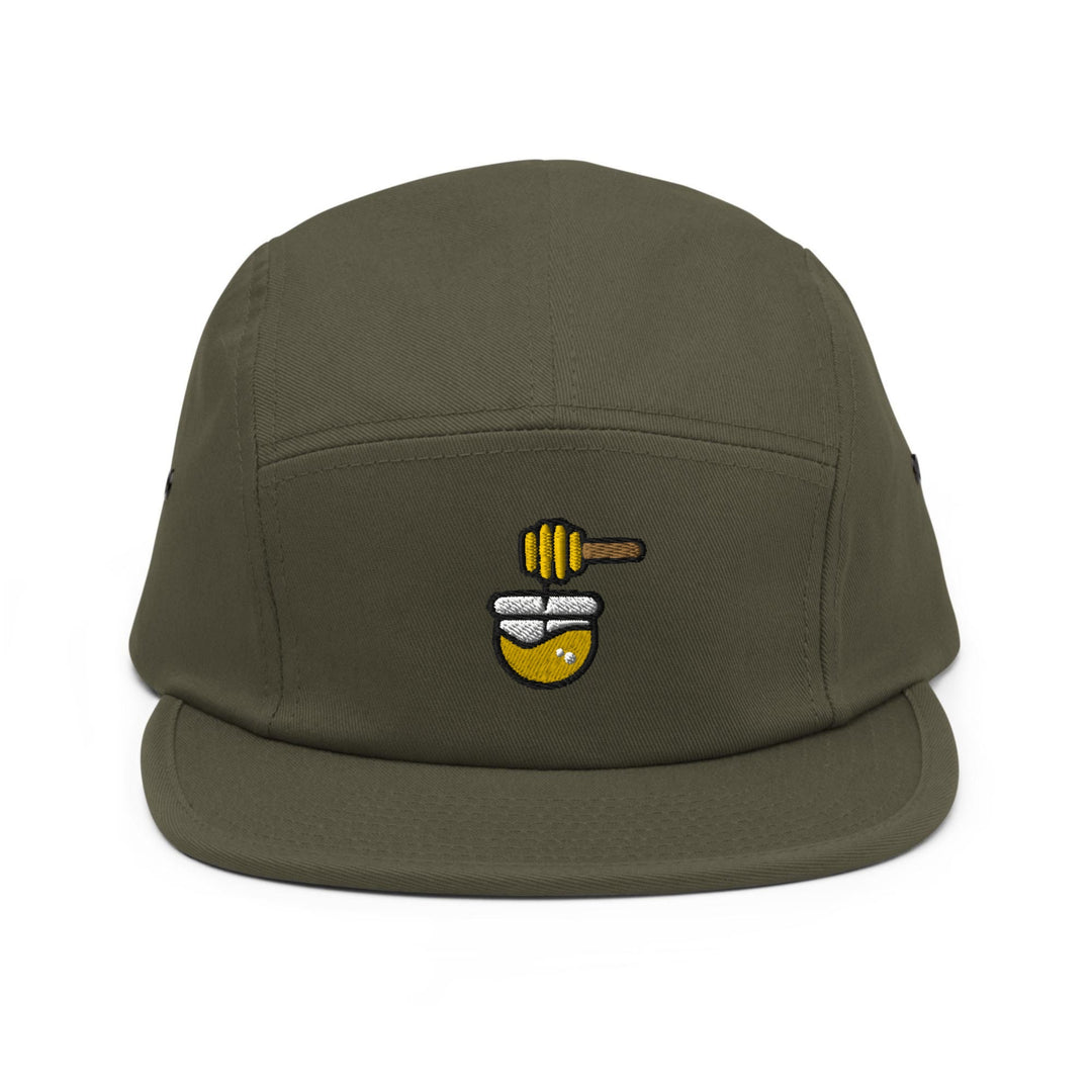 a green hat with a bee on it