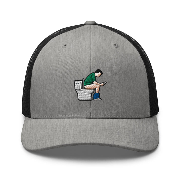 a gray and black hat with a man sitting on a toilet