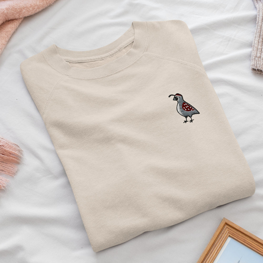 a t - shirt with a bird embroidered on it
