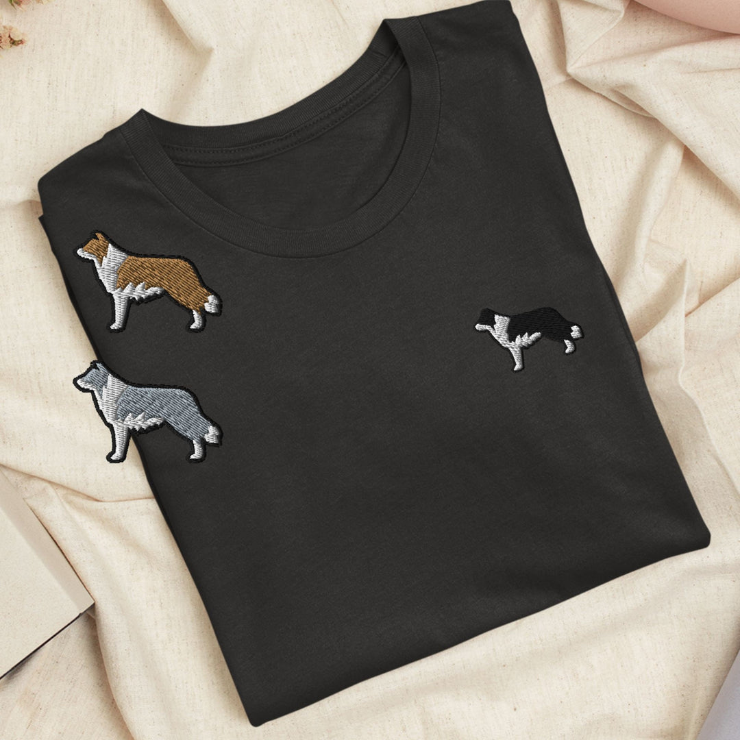 a black t - shirt with three dogs on it