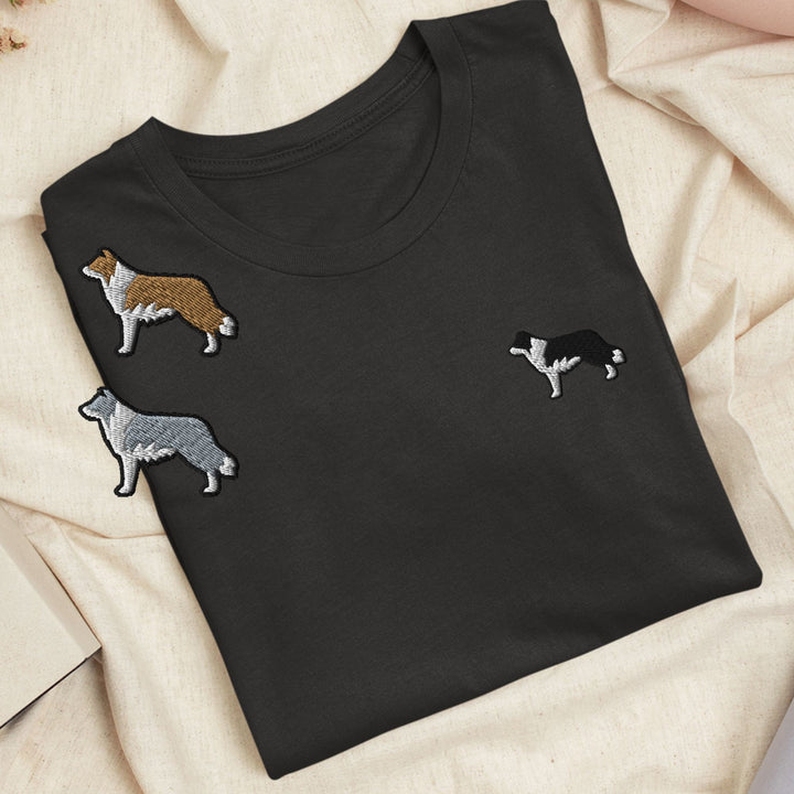 a black t - shirt with three dogs on it
