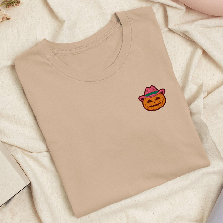 a t - shirt with a picture of a pumpkin wearing a cowboy hat