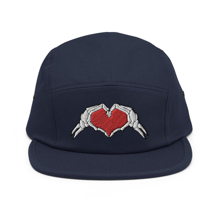 a baseball cap with two hands holding a heart