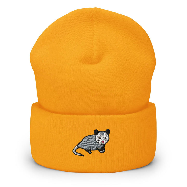 a yellow beanie with a cartoon rat on it