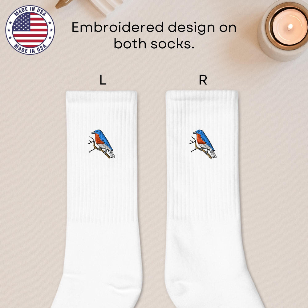 a pair of white socks with a blue and red bird on it