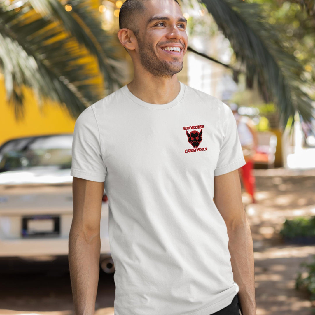 a man in a white t - shirt smiles at the camera